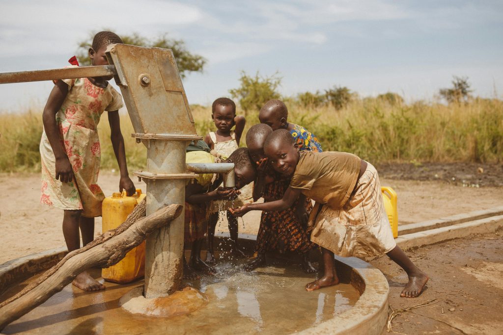 Group of children gathering water from a well in Kitgum, Uganda. They risk being affected by the USAID freeze.